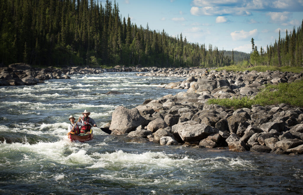 Yellowknife, NWT - Steve Dunn pilots Chris Pulsifer through a tricky run during a 10-day, 195km river run from Upper Carp Lake to Great Slave Lake on the Yellowknife River, NWT.