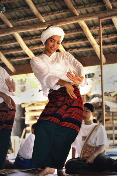 A young Thai dancer moves rythmically to the music of Somboon Gavichi’s stringed 'salor'.