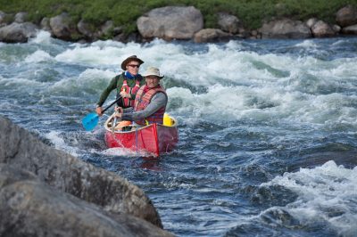 Yellowknife, NWT - Jack Stefanyk pulls a fast bow cross draw as Rylie Braun cooly tillers through a rough section on the Yellowknife River.