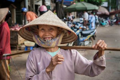 Toothy grin from elderly Black Thai woman