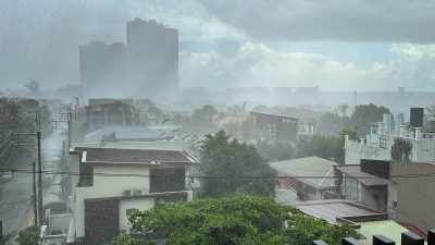 Heavy rains wash over the streets of Kapitolyio, Pasig City, Manila, Philippines during Easter Holy Week.